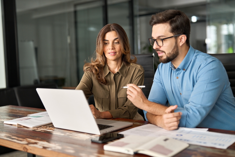 Female professional showing changes on a computer.